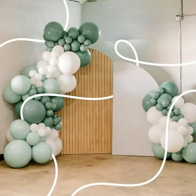 Wooden arch backdrop with sage balloons