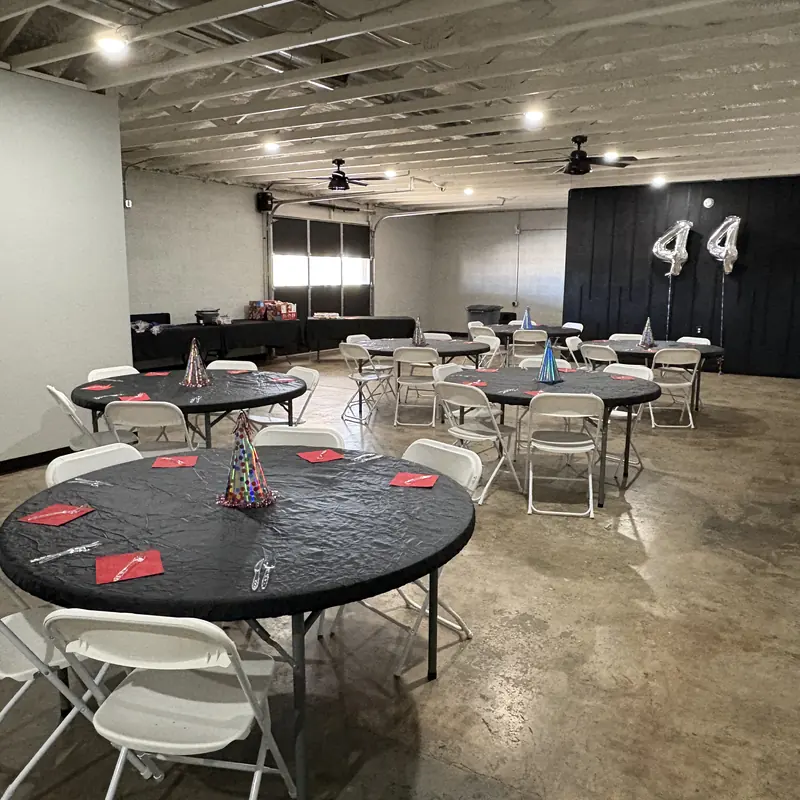 Black tables set for a 44th birthday