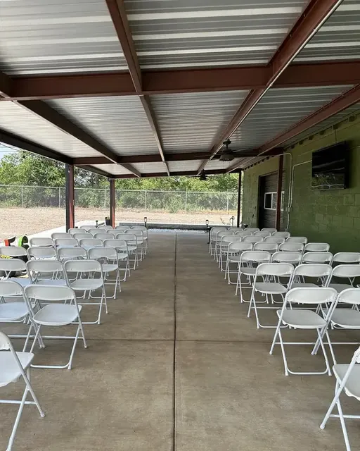 White chairs set in rows on the covered patio